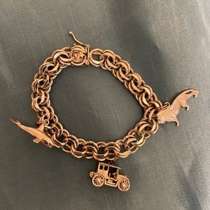 Sterling Charm Bracelet.  Includes three charms.  Whale car, and lion.